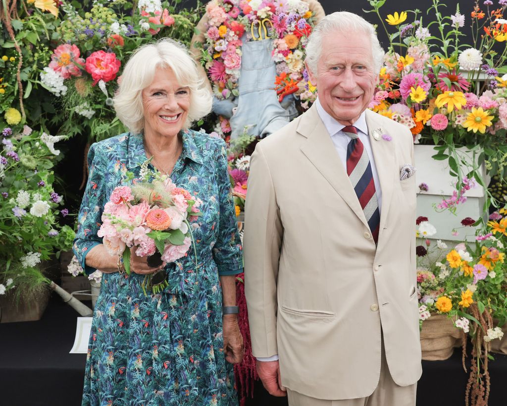 Charles and Camilla surrounded by flowers in Sandringham