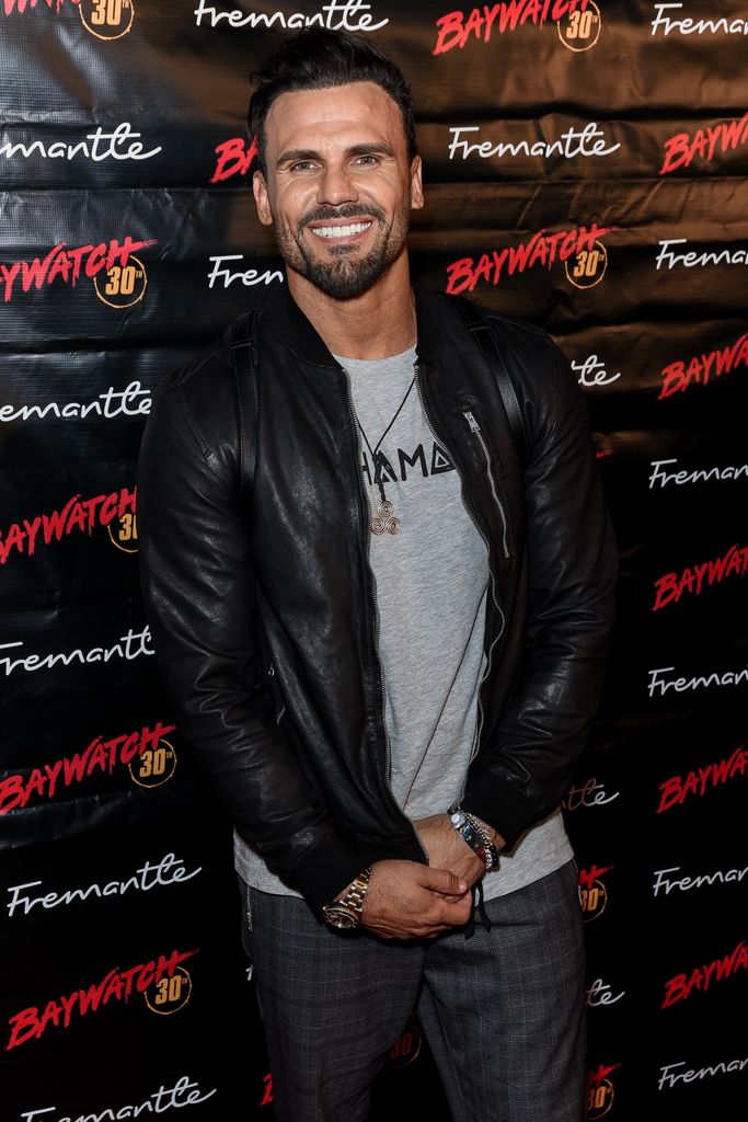 Jeremy Jackson attends 30th Anniversary of "Baywatch" wearing a leather jacket