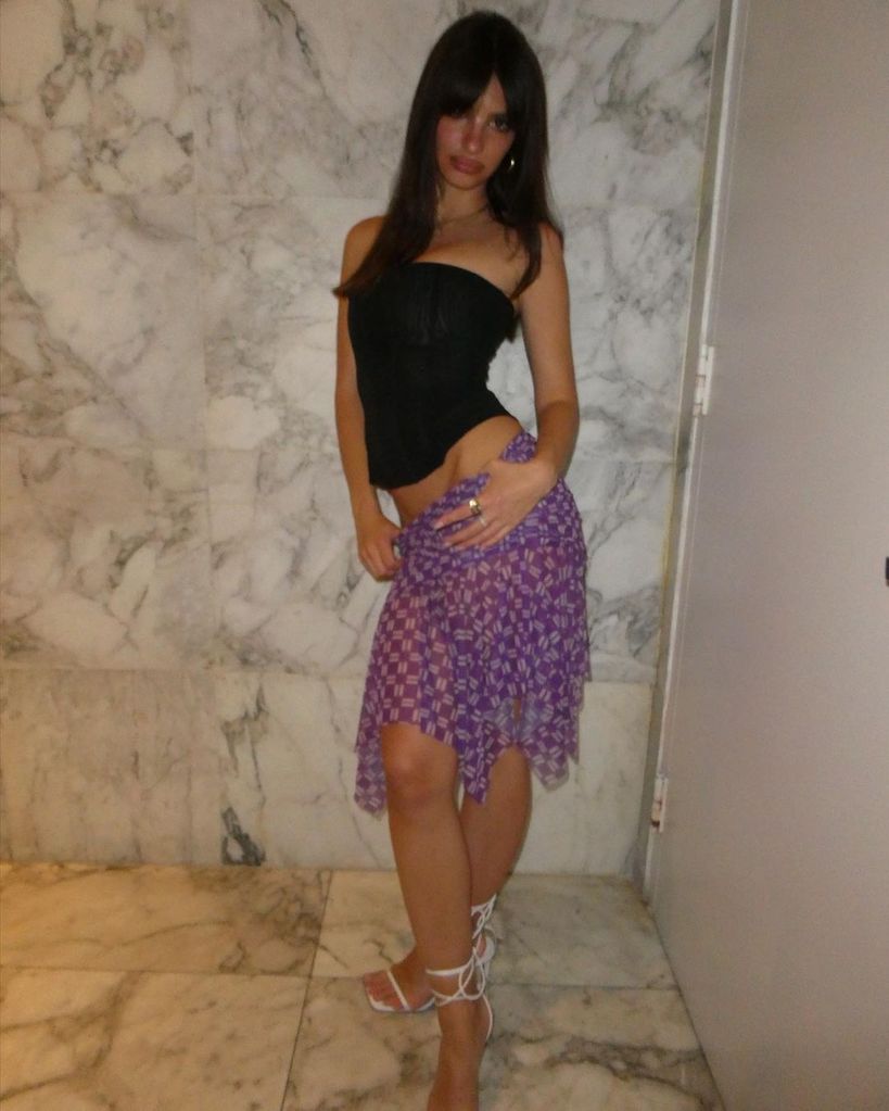 Emily Ratajkowksi in a purple skirt