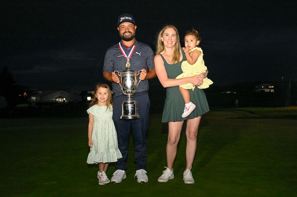 photo of jj spaun holding us open trophy with wife and two kids