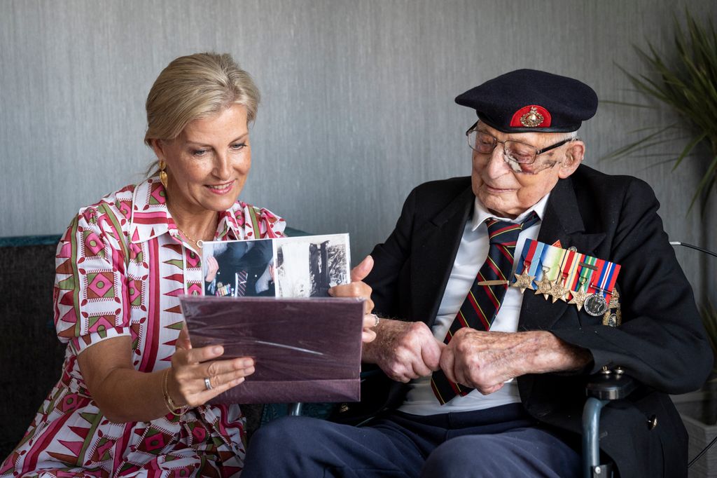 Britain's Sophie, Duchess of Edinburgh meets 105-year-old Royal Marines veteran James 'Jim' Wren (R) at the Sarum Manor Care Home in Salisbury on August 12, 2025, ahead of 80th anniversary of VJ Day