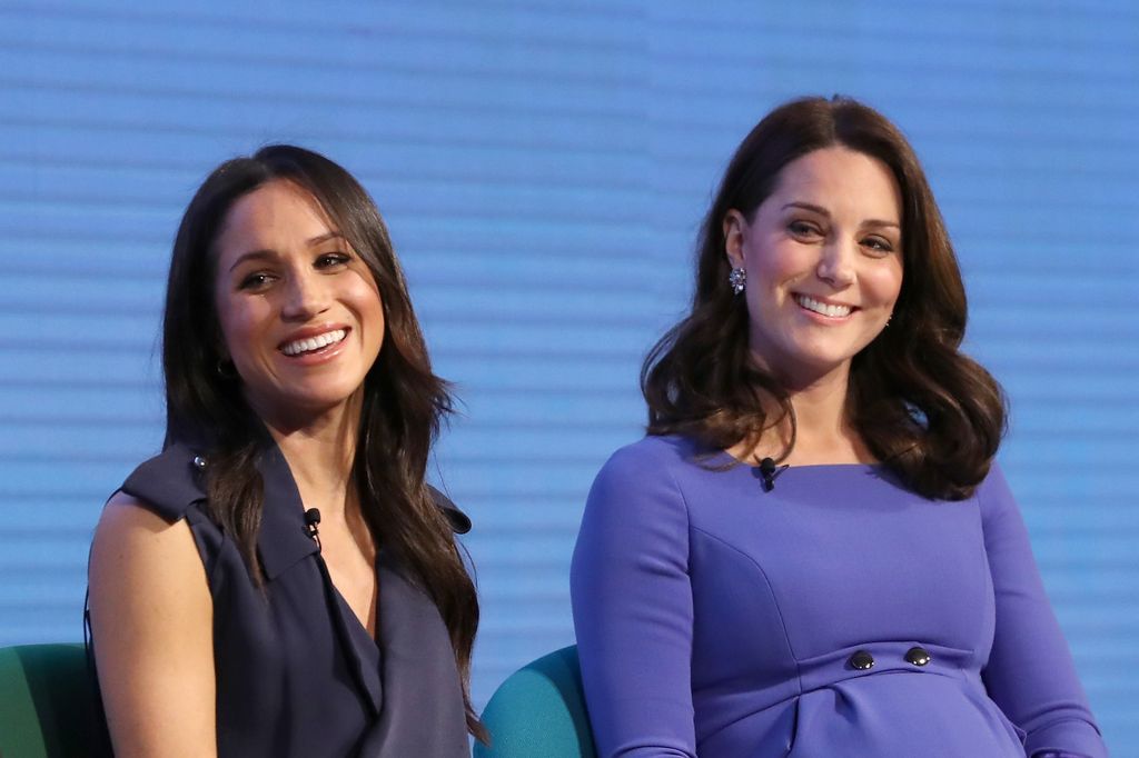 Meghan and Princess Kate smiling on stage in 2018