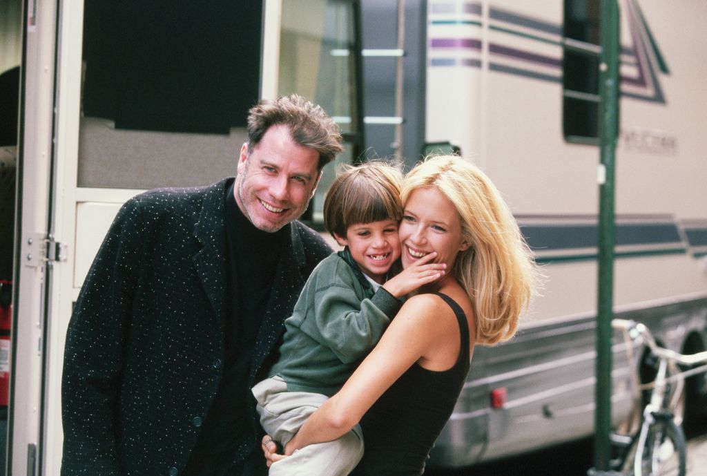 Actress Kelly Preston gets a visit from husband John Travolta (L) and son Jett while on location filming the 1997 motion picture "Addicted to Love."   (Photo by Mitchell Gerber/Corbis/VCG via Getty Images)