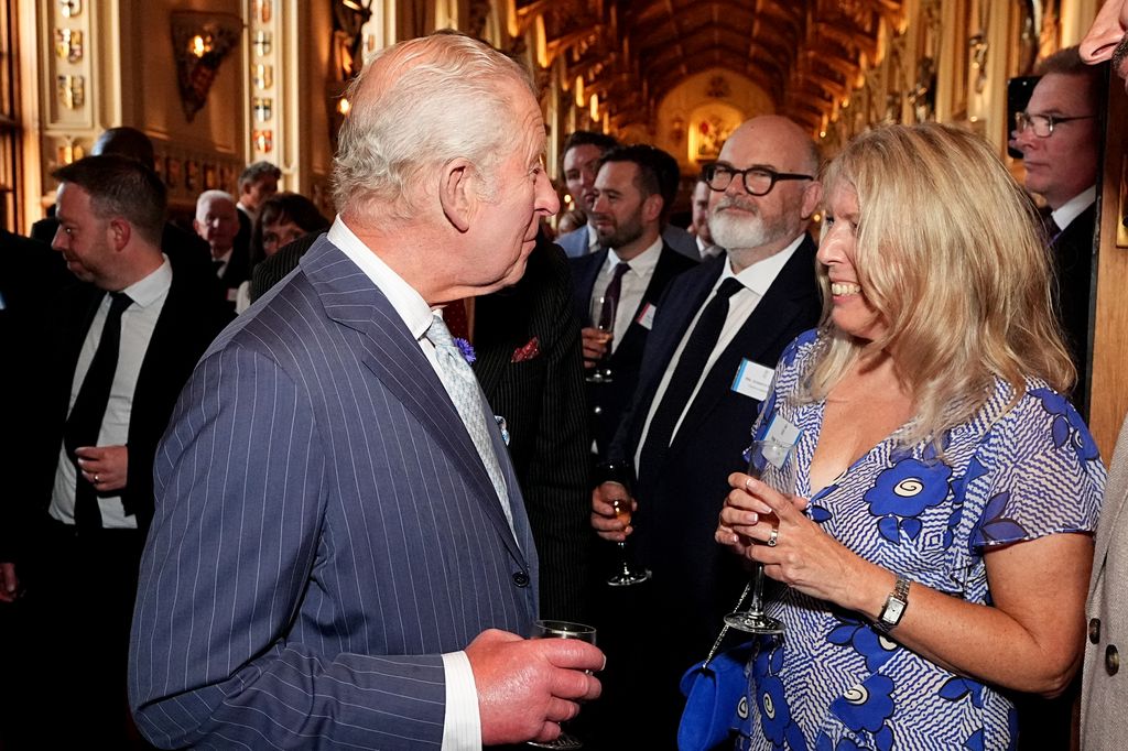 Britain's King Charles III speaks to Lisa Kay during a reception for recipients of The King's Award for Enterprise 