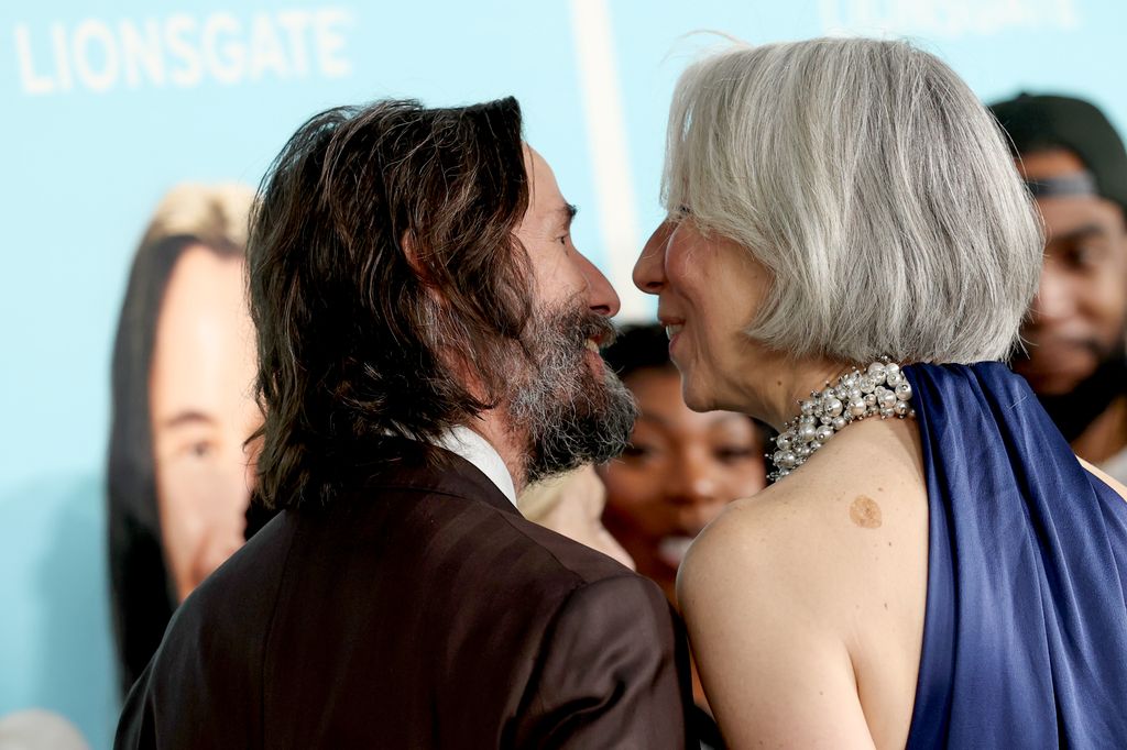 photo of keanu reeves looking at girlfriend alexandra grant on red carpet