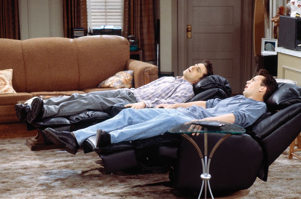 Chandler and Joey relaxing in their apartment