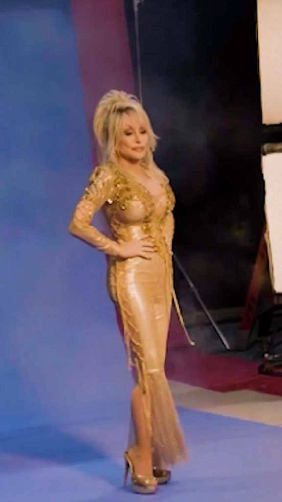 Dolly Parton in low cut gold flared bodysuit during Let It Be single promo