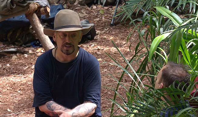 boy george in jungle with hat and t shirt on 