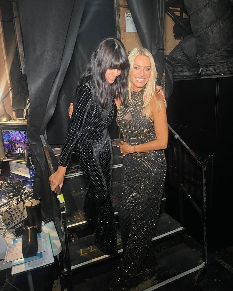 Claudia Winkleman in black suit and Tess Daly in sparkly gold jumpsuit