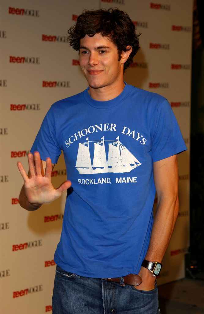 Adam Brody is a blue top waving