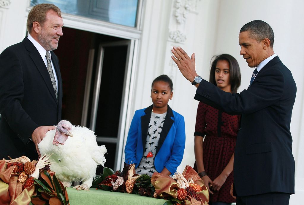 U.S. President Barack Obama is flanked by his daughters Sasha (C), Malia (2nd-R), and National Turkey Federation Chairman Richard Huisinga (L) as he pardons 'Liberty', a 19-week old, 45-pound turkey at the North Portico of the White House November 23, 2011 in Washington, DC. The Presidential pardon of a turkey has been a long time Thanksgiving tradition that dates back to the Harry Truman administration.