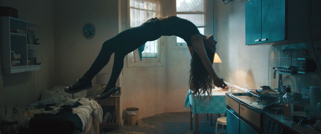 Morfydd Clark as Maud levitating in a still from Saint Maud