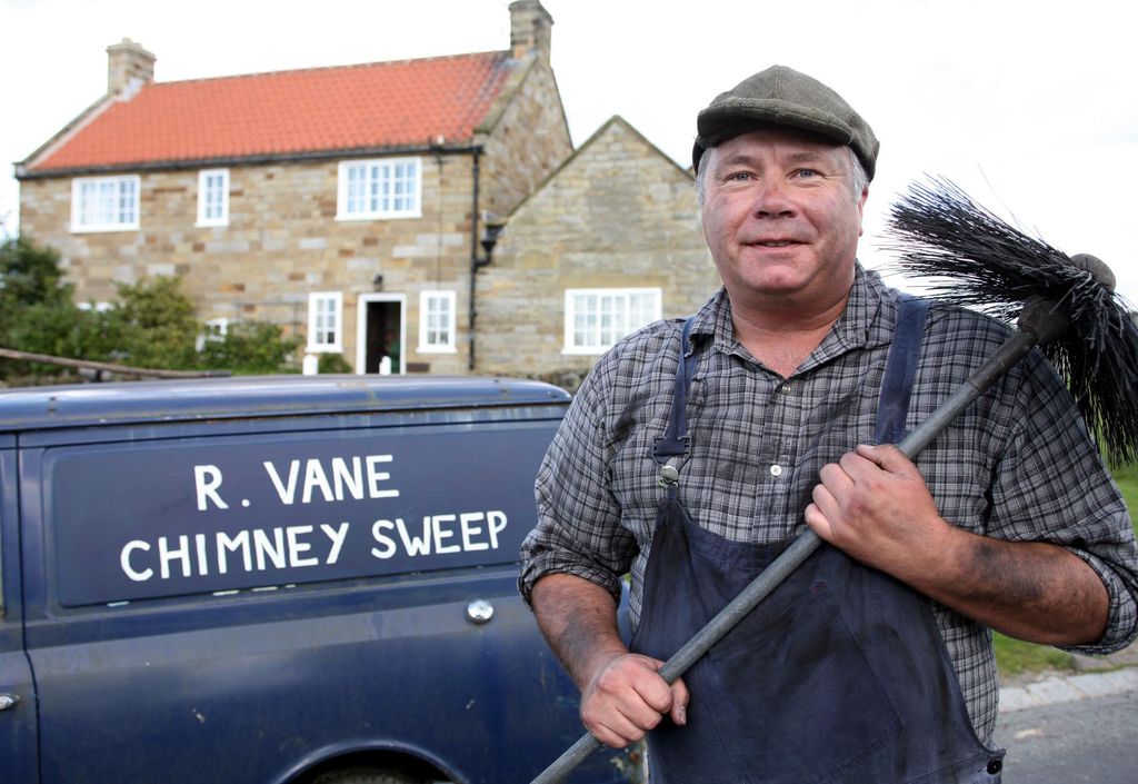 David Lonsdale in character as David Stockwell holding a chimney sweep