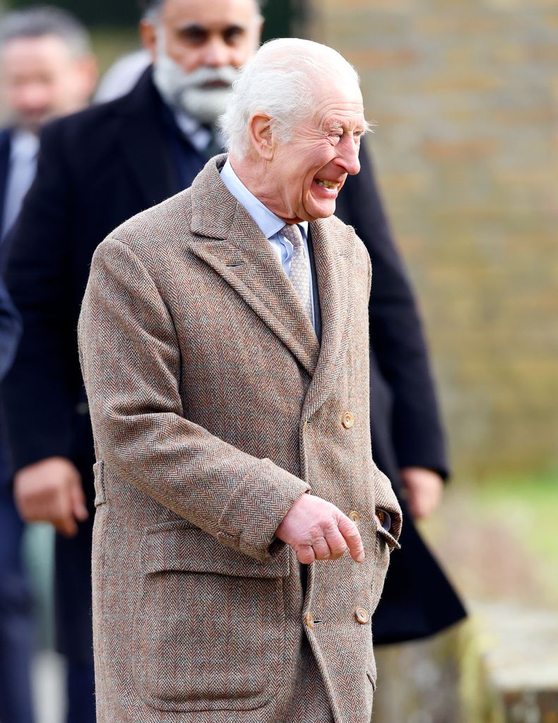 king charles laughing outside in wool coat