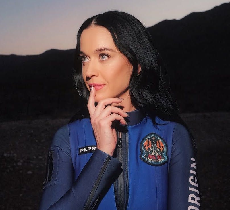 Katy Perry looks into the distance wearing space suit