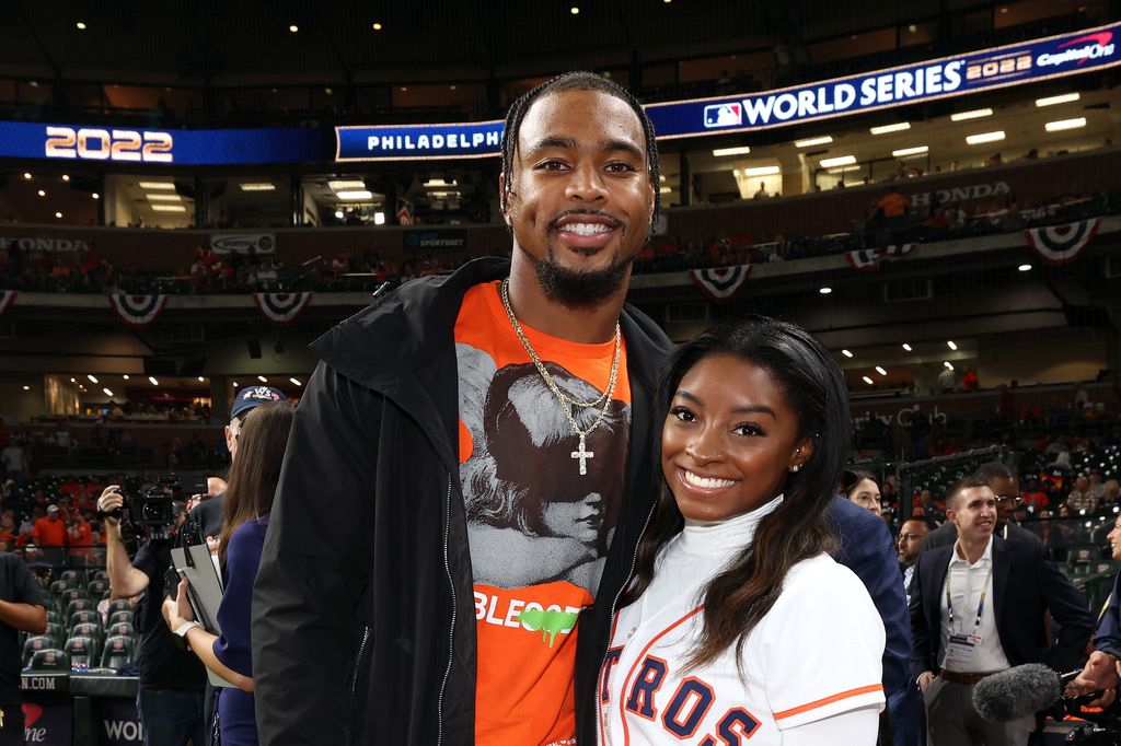 Simone Biles and Houston Texans safety Jonathan Owens are seen prior to Game 1 of the 2022 World Series between the Philadelphia Phillies and the Houston Astros at Minute Maid Park on Friday, October 28, 2022 in Houston, Texas