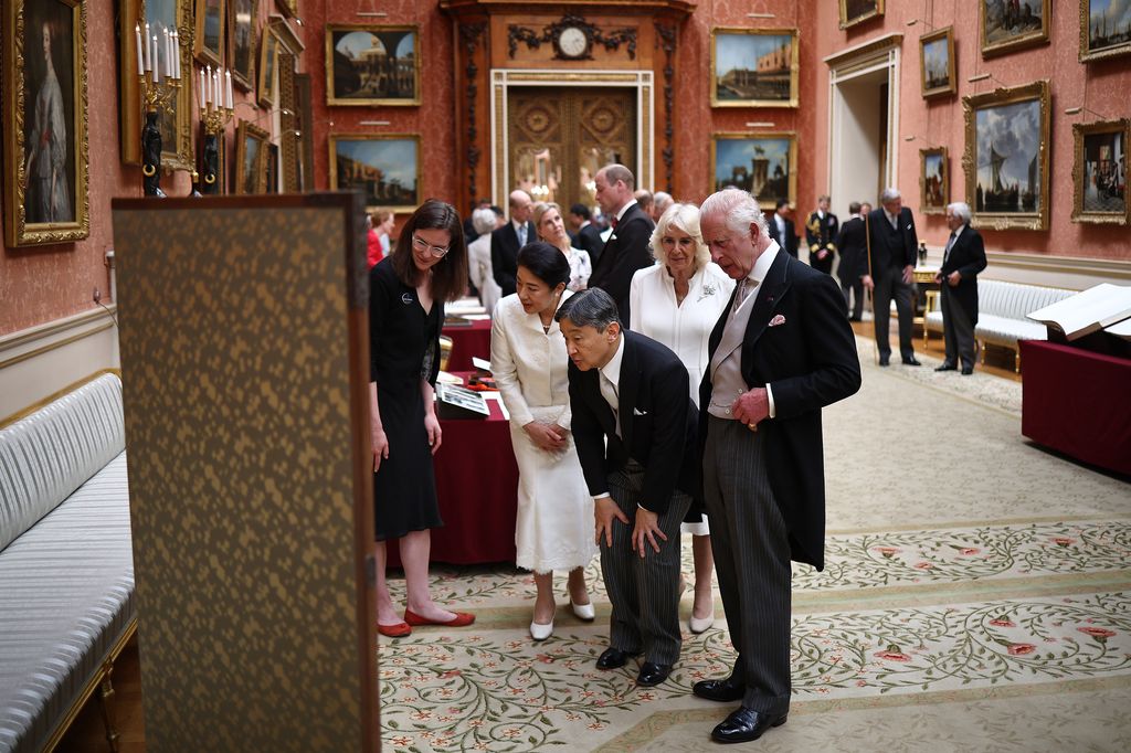 King Charles walks with Japan's Emperor Naruhito, followed by Queen Camilla and Japan's Empress Masako, as they view a display of Japanese items from the Royal Collection