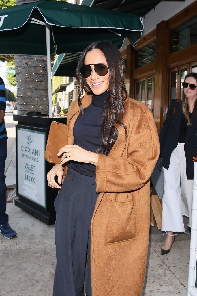 SINGLE USE! Meghan Markle was spotted leaving Cipriani restaurant after enjoying a delightful lunch with friends, looking elegant in a brown coat and black tailored pants.
