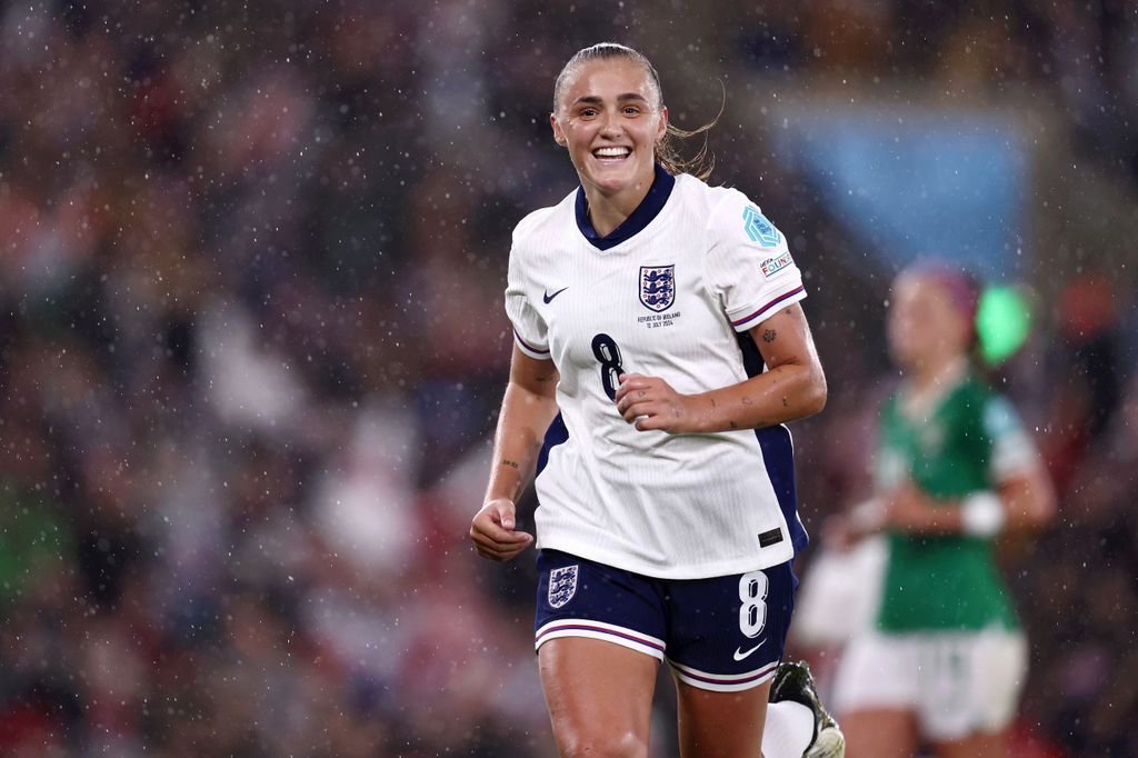 Georgia Stanway smiling in rain in football kit
