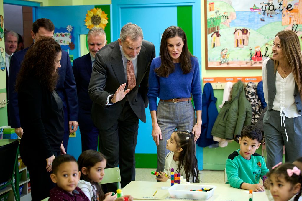 King Felipe and Queen Letizia meeting children at the school