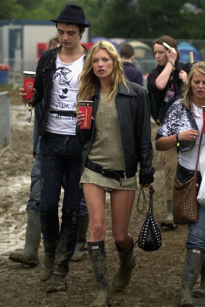  Kate Moss attends Glastonbury in 2005 wearing a gold dress, wellington boots and a leather jacket