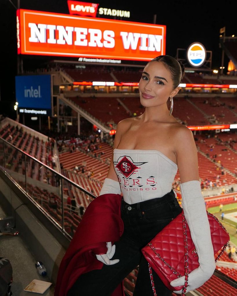 Olivia dons a Kristin Juszczyk-made jersey at the 49ers game