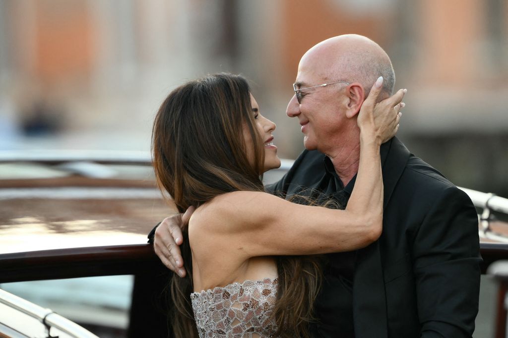 Amazon's founder Jeff Bezos and spouse Lauren Sanchez Bezos kiss as they leave the Aman Hotel 