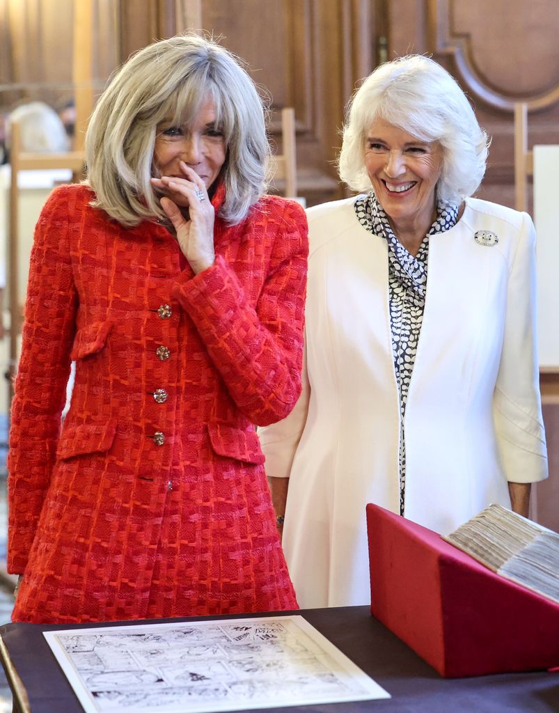 Mrs Macron and Camilla share a joke at the National Library