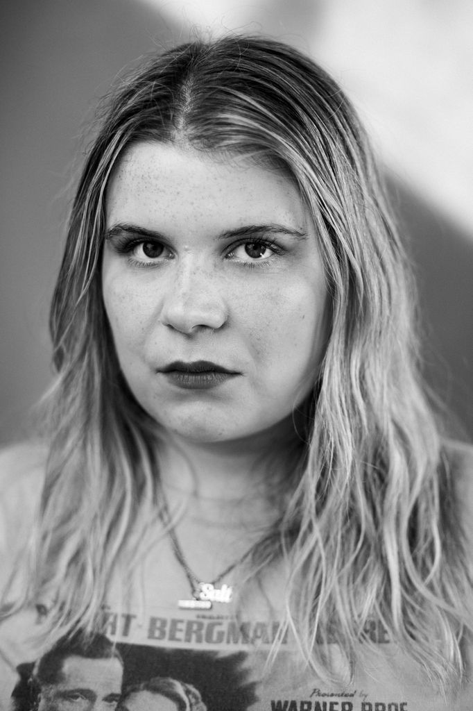 A black and white picture of a blonde woman