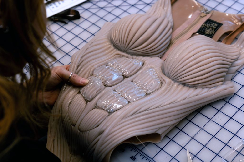 A BTS photo from the creation of Doja Cat's bodysuit for her Coachella performance by Asher Levine