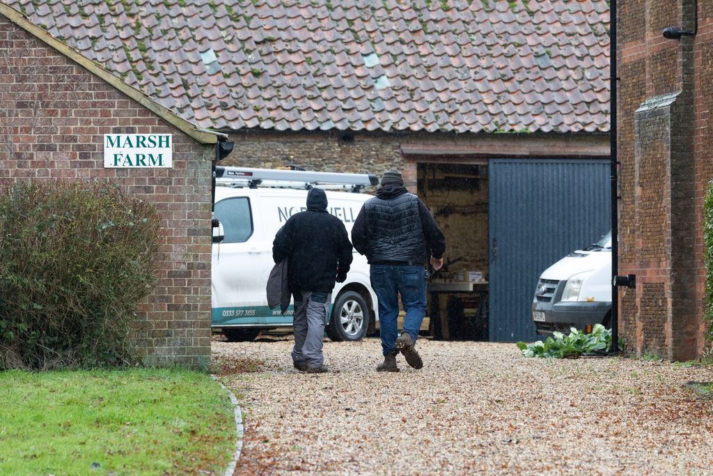 workmen at Marsh Farm with white vans
