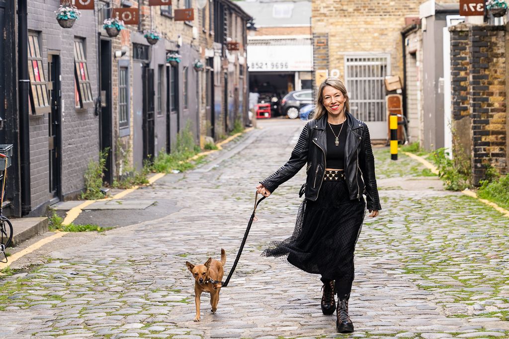 Woman walking her dog along a city street