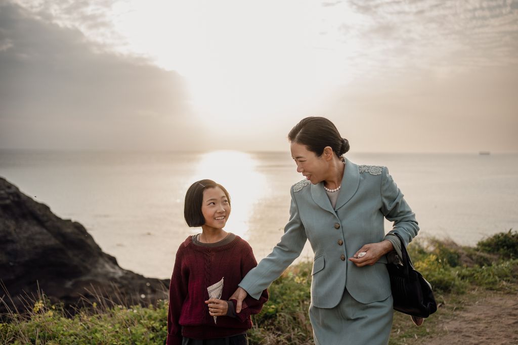 mother and daugter walking on clifftop