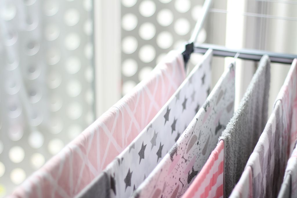 laundry and clothes hanging indoors on a hanging rack
