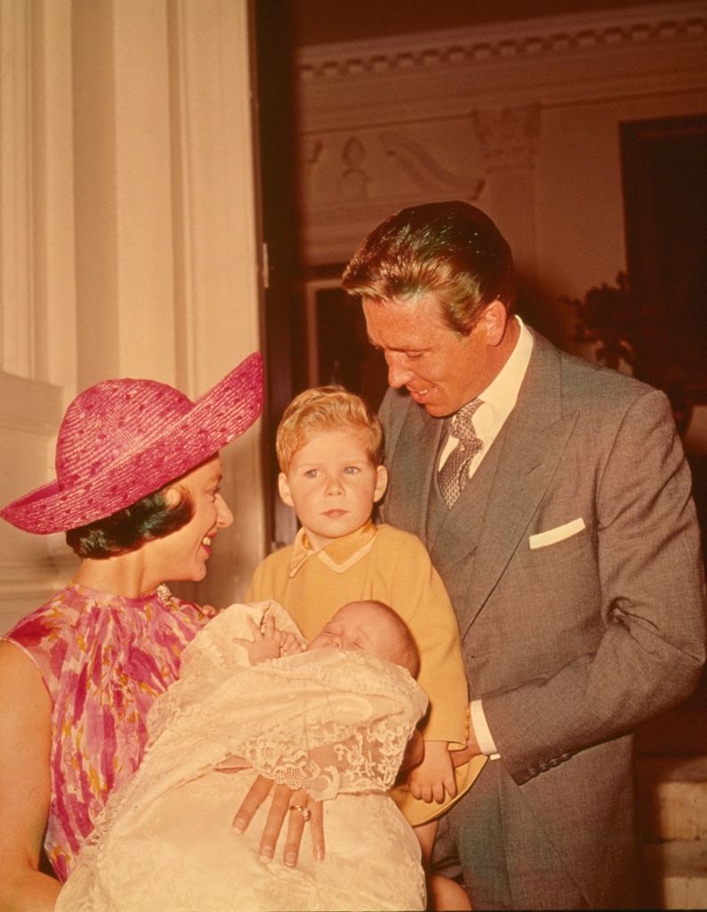 Princess Margaret holding a baby Lady Sarah Chatto alongside Antony and David Armstrong-Jones