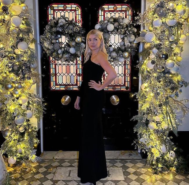 holly willoughby in black dress outside christmas door
