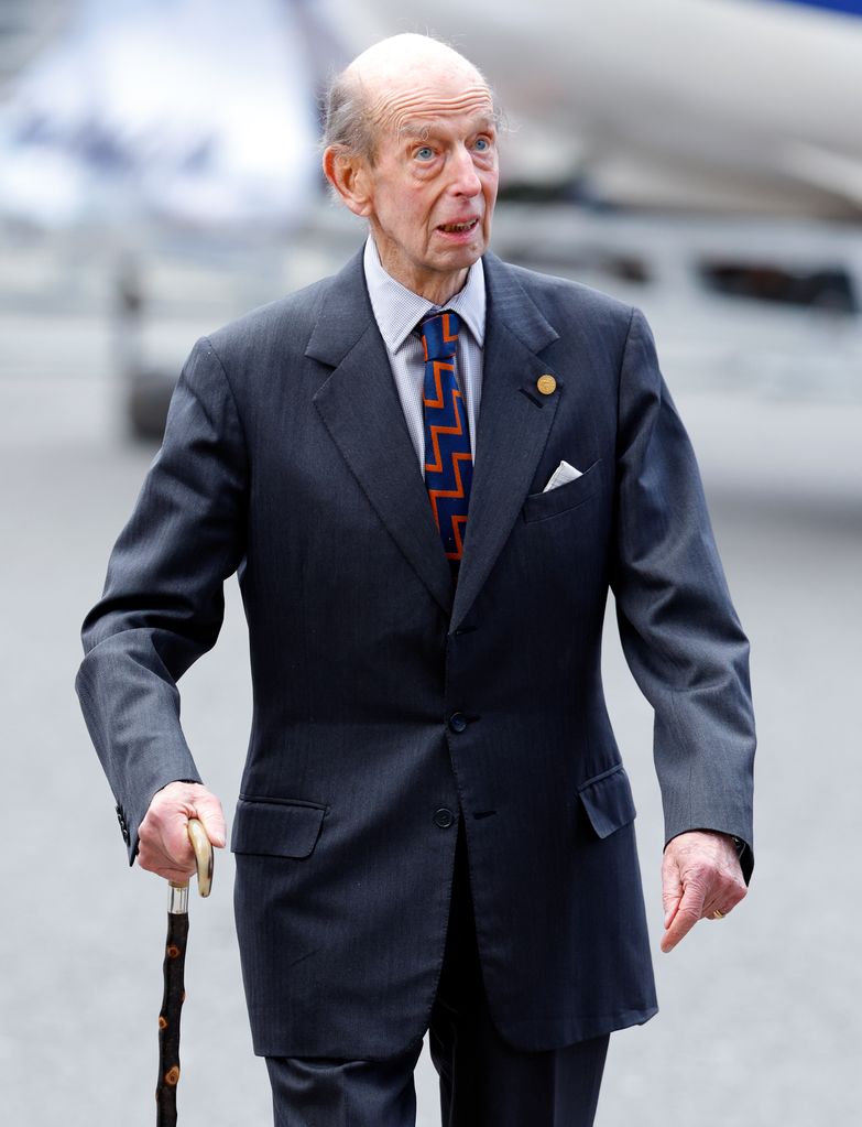 Prince Edward, Duke of Kent in a grey suit with a walking stick