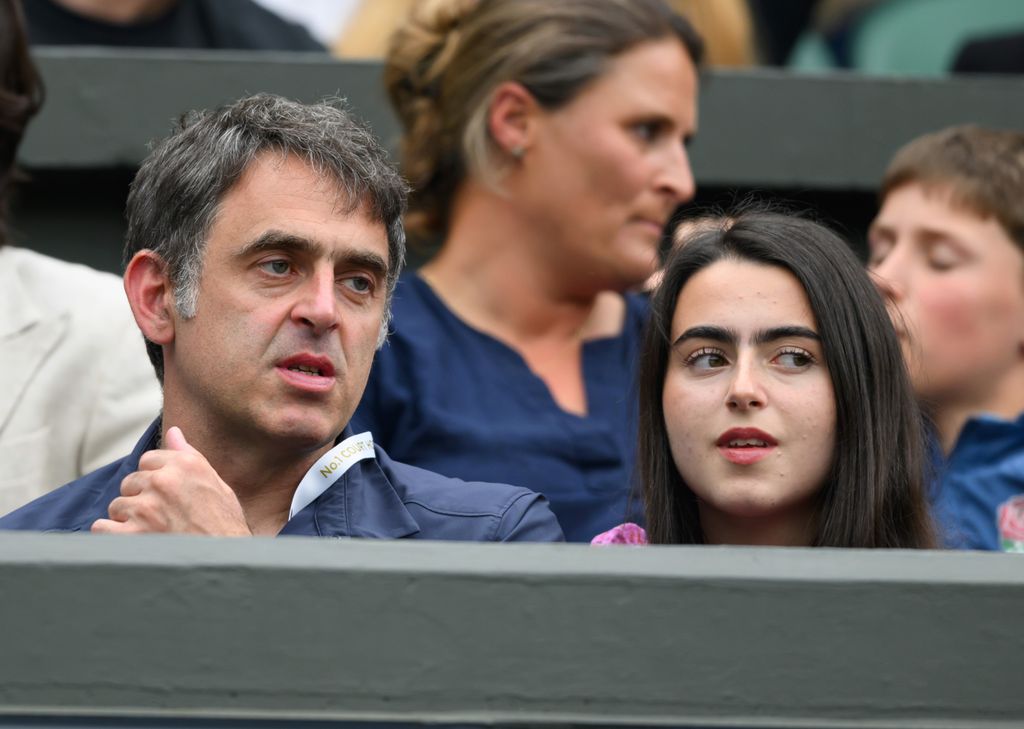 father and daughter talking at tennis match
