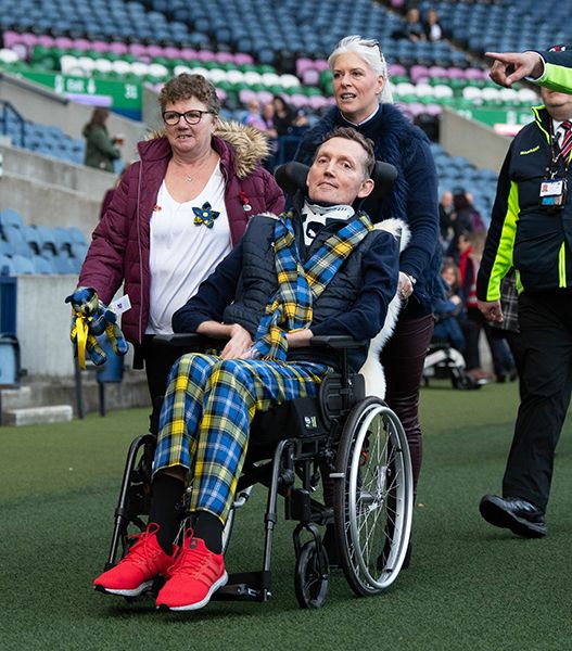 Doddie Weir being pushed in wheelchair