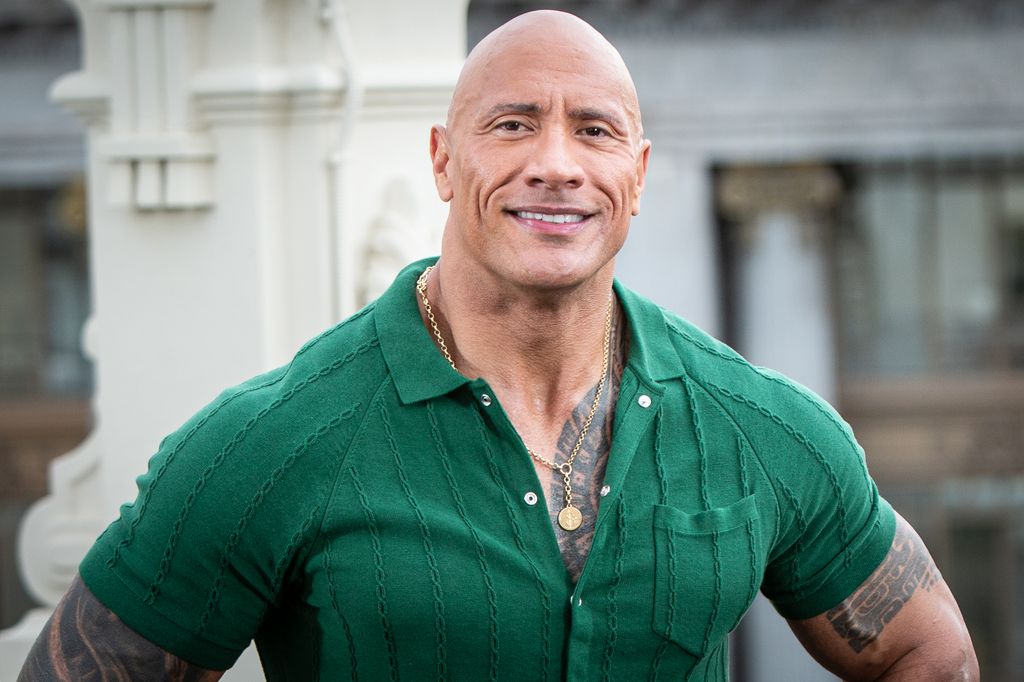 Dwayne shows off tattoos and muscles in tight green t-shirt 