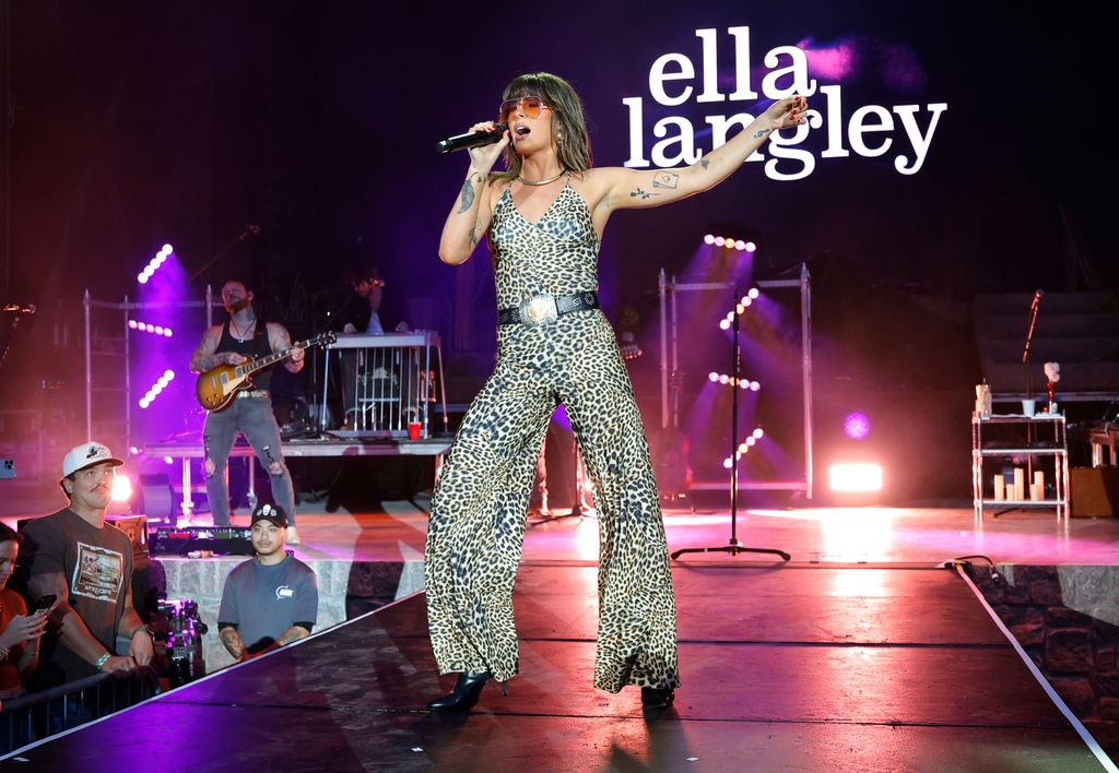 ella langley on stage in animal print jumpsuit