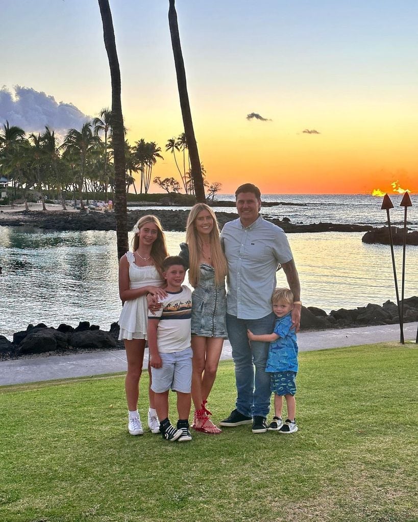 Christina Hall and Josh with their blended family in front of a sunset