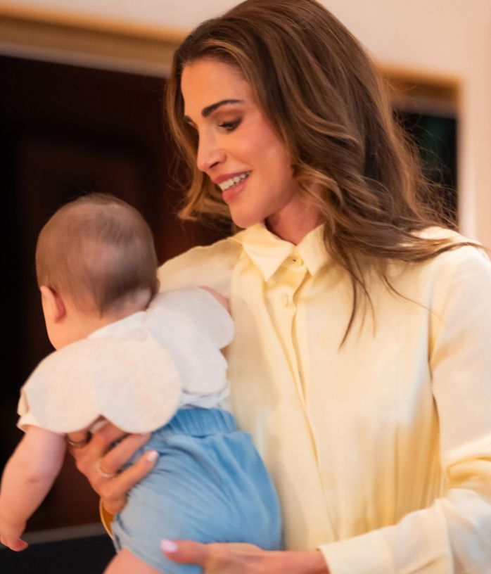 Queen Rania cuddling her granddaughter, Amina