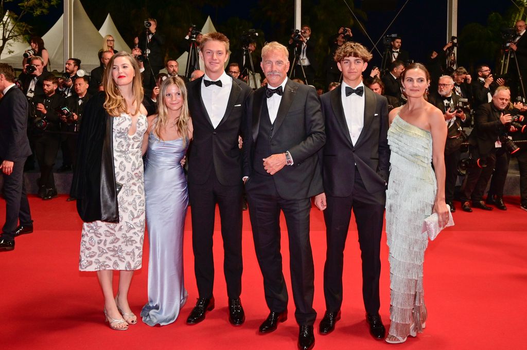Cayden Wyatt Costner Lily Costner, Hayes Costner, Grace Avery Costner, Kevin Costner and Annie Costner depart the "Horizon: An American Saga" Red Carpet at the 77th annual Cannes Film Festival at Palais des Festivals on May 19, 2024 in Cannes, France.
