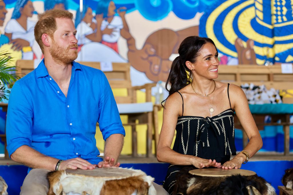 Prince Harry and Meghan Markle playing drums