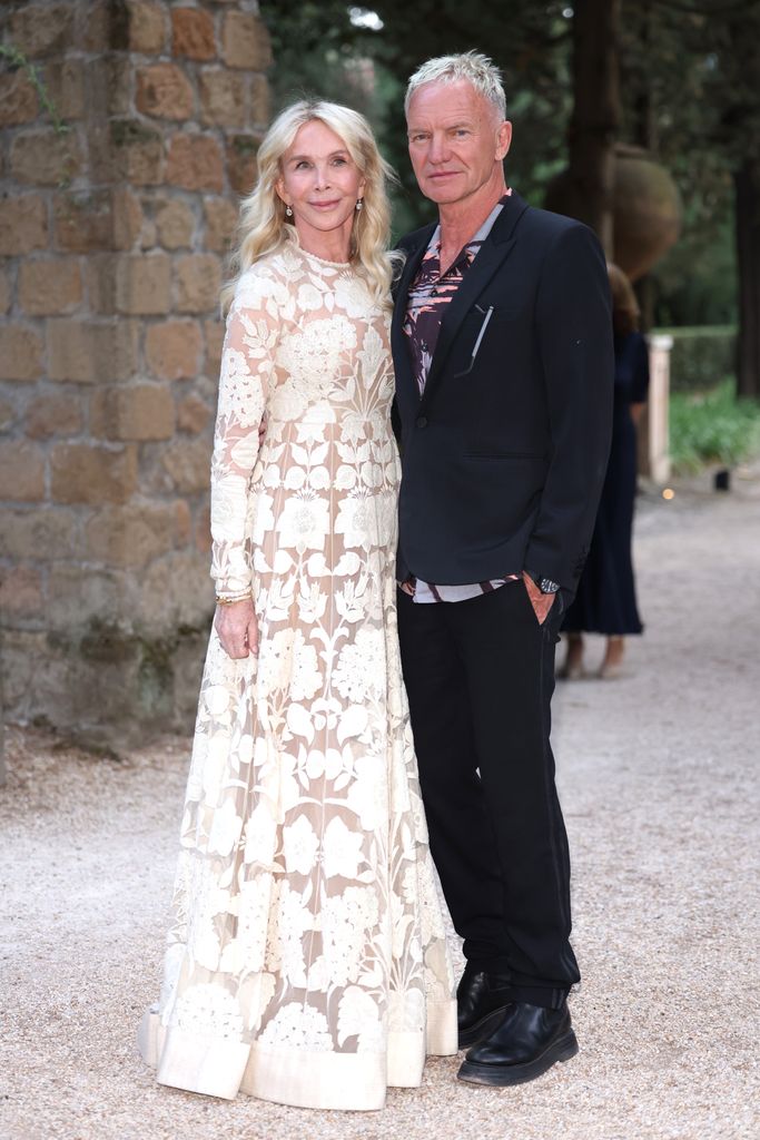 Trudie Styler in white dress and Sting posed outside in rome