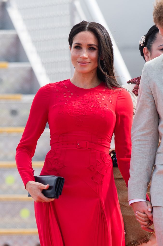 Meghan Markle disembarking aircraft in red dress