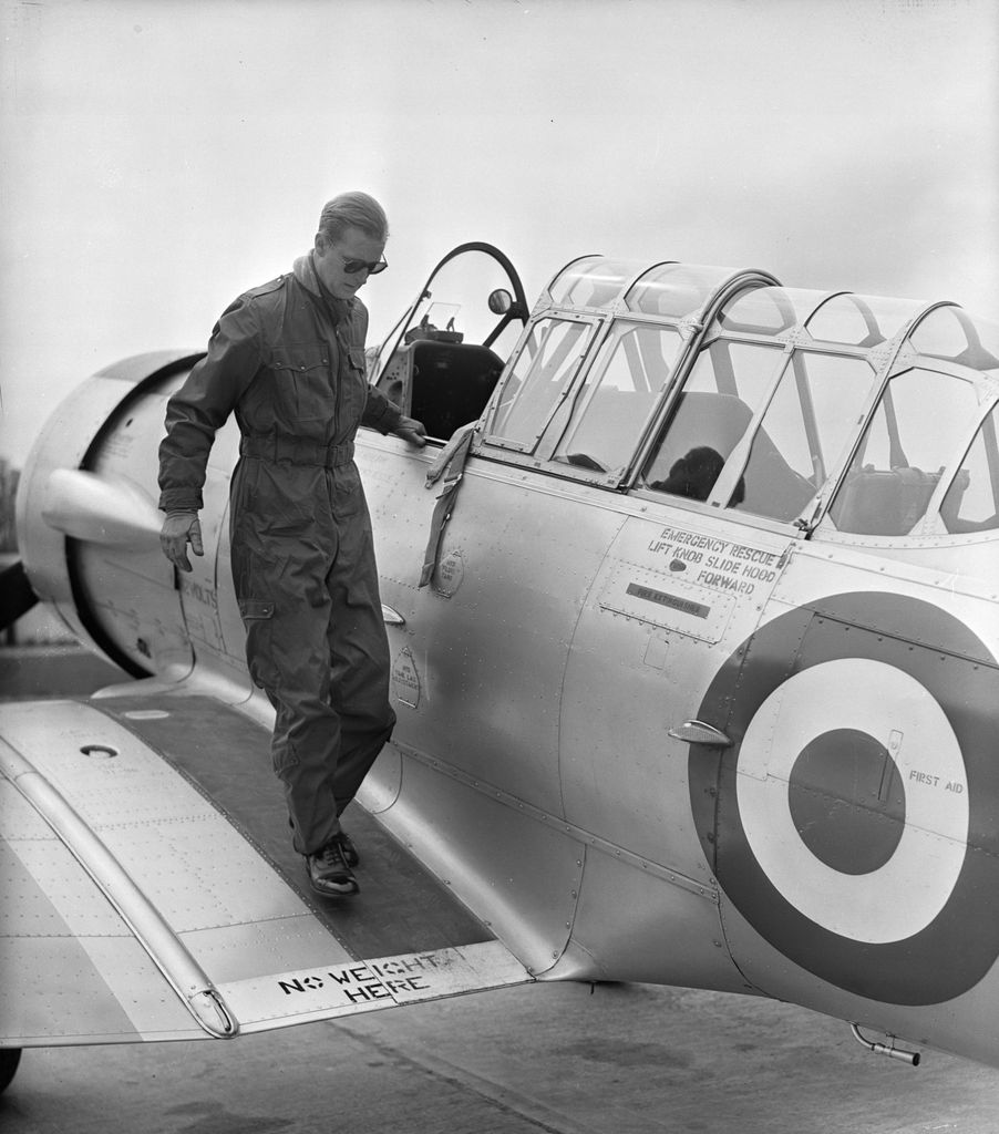 The Duke of Edinburgh disembarks from a North American Harvard Trainer aircraft after a flight, at RAF White Waltham, Berkshire, where he has been training for his 'wings'