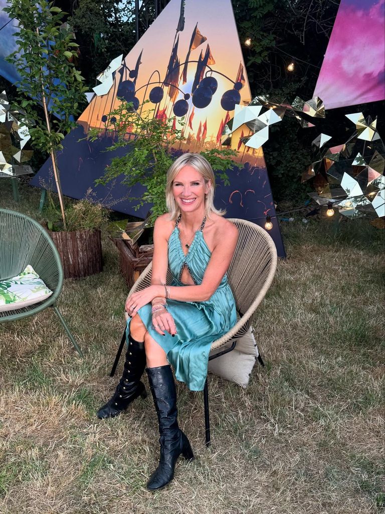 jo whiley outside in chair wearing blue dress and black boots