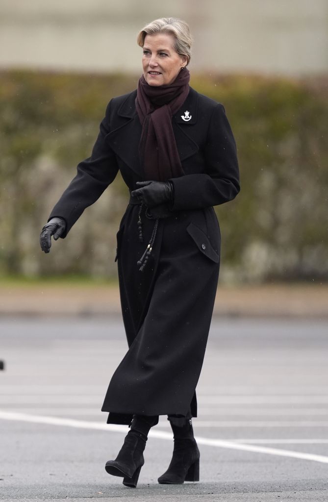 The Duchess of Edinburgh wore a black coat, matching boots and a chocolate brown scarf